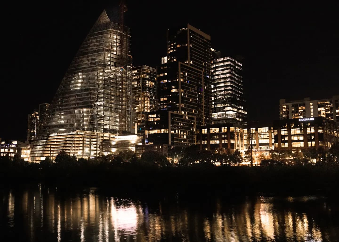 Downtown Austin at night, reflected in the river