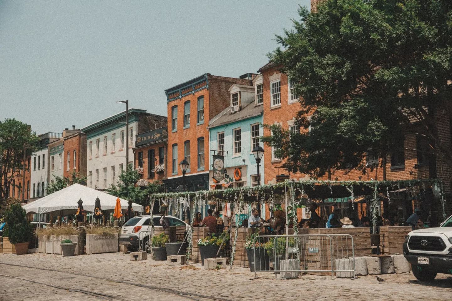 Rowhouses and sidewalk cafes on a street in Baltimore