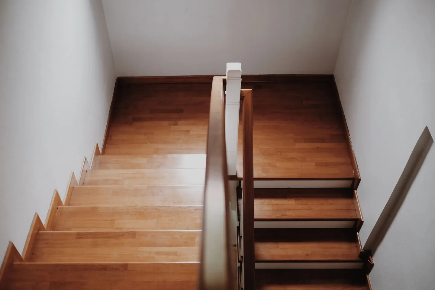 Wooden staircase and handrail viewed from above