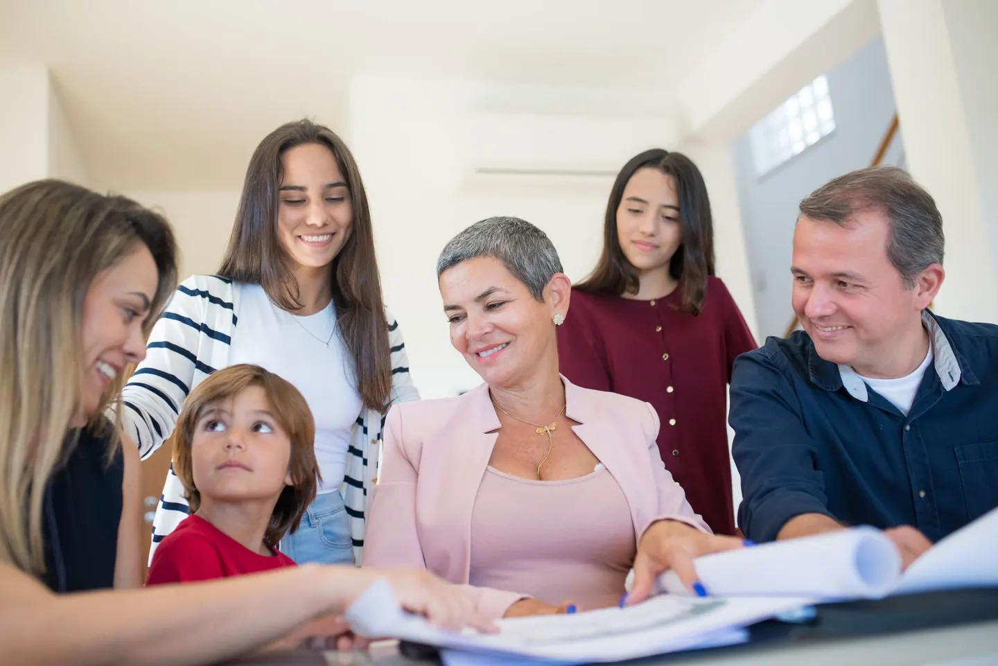 Family reviewing documents at a table with an adviser