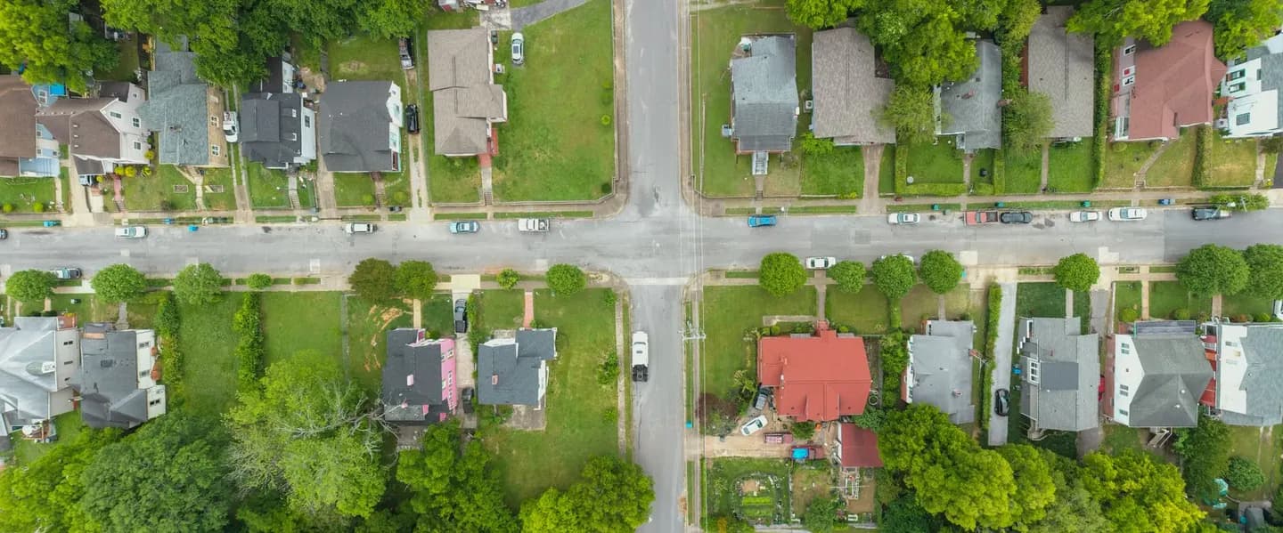 An aerial view of a suburban neighborhood intersection