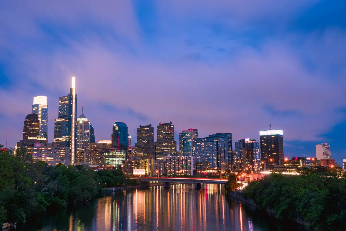 The Philadelphia skyline at dusk, reflected in the river