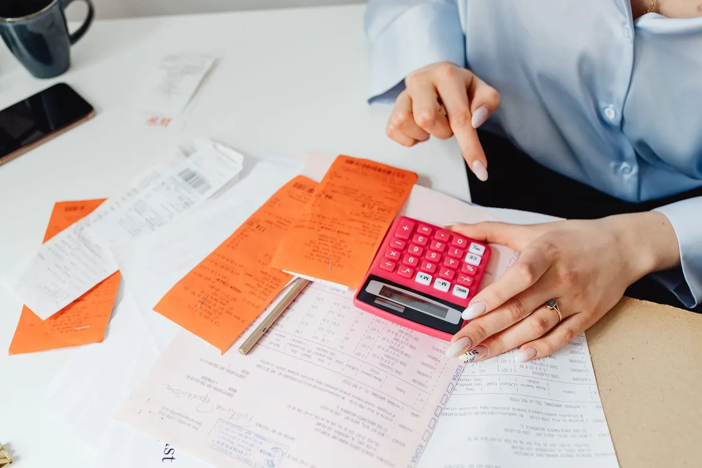 Receipts, paperwork and a calculator on a desk