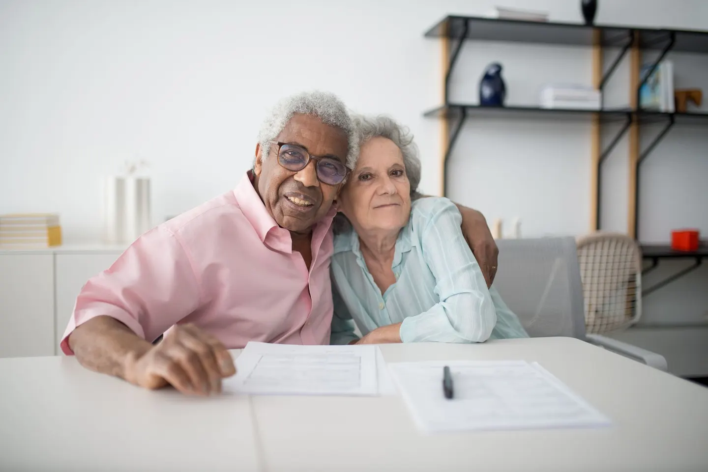 An older couple reading documents together at a table