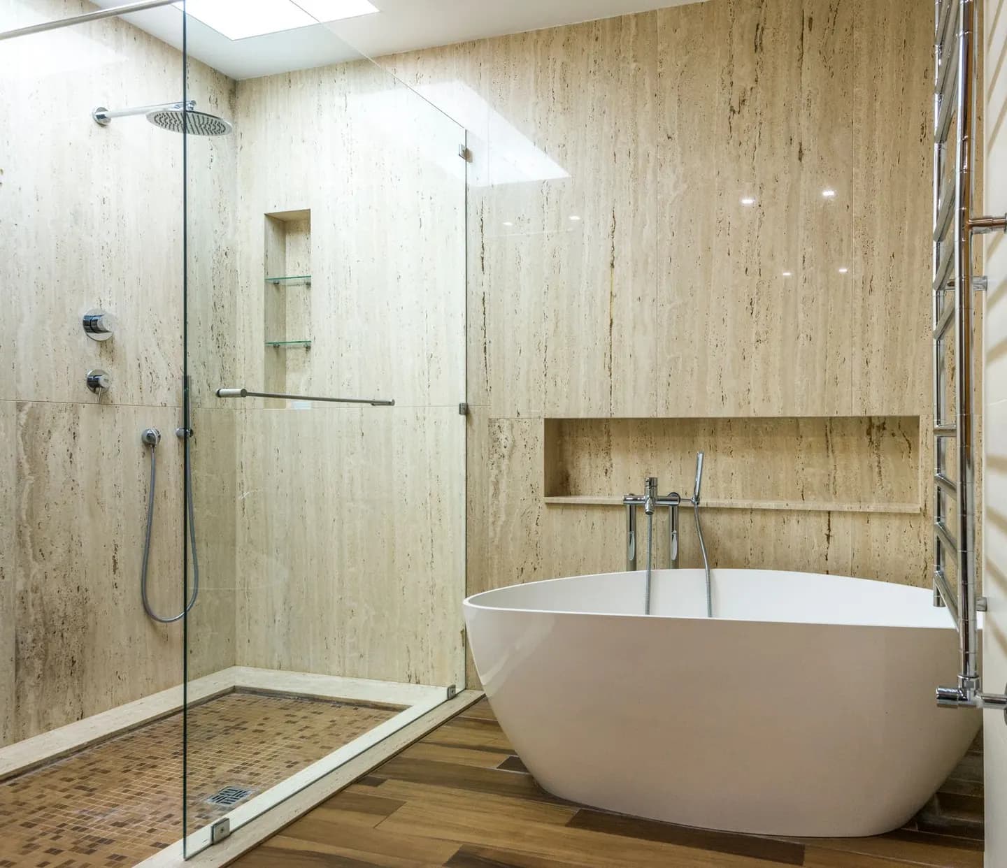 A bathroom with a glass walk-in shower beside a bathtub