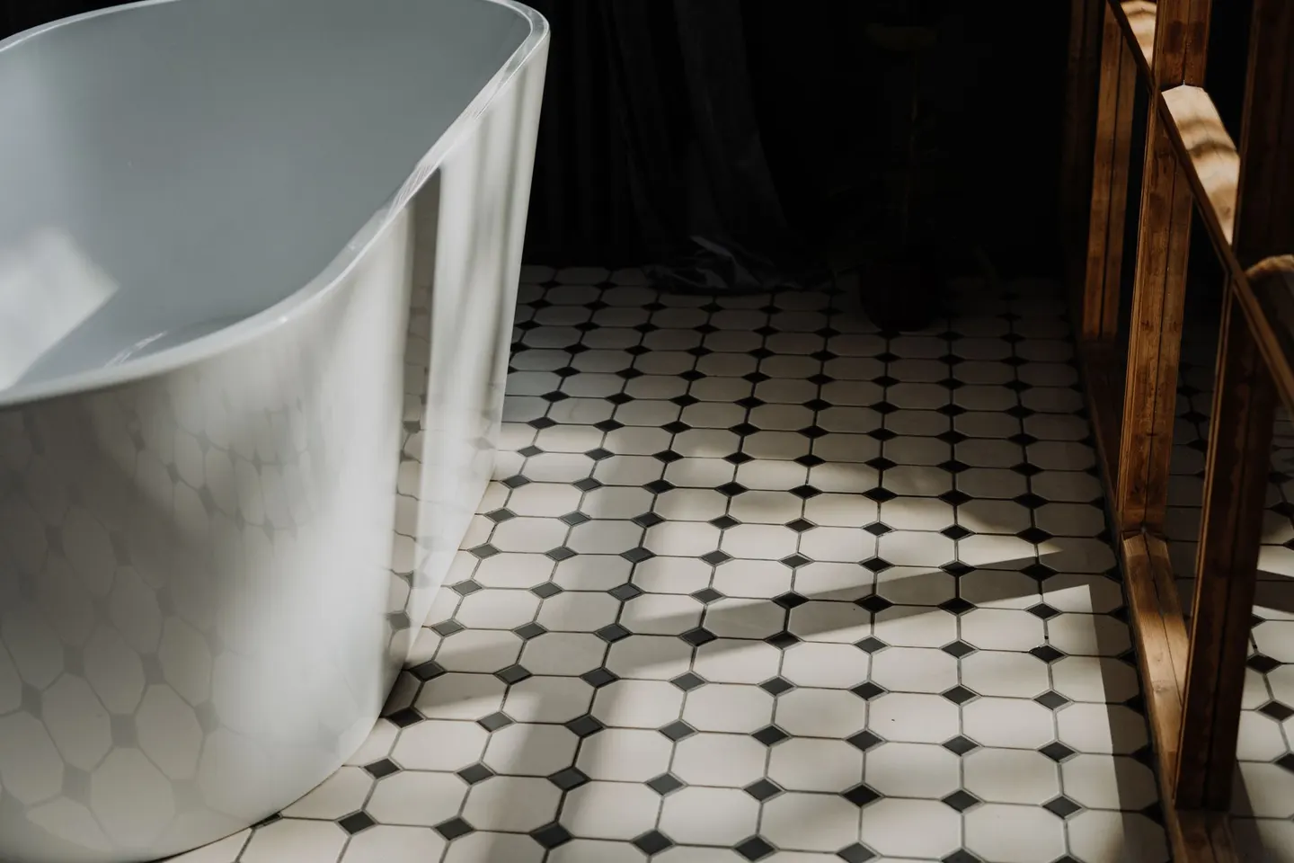 Small octagon-and-dot tile floor beside a bathtub