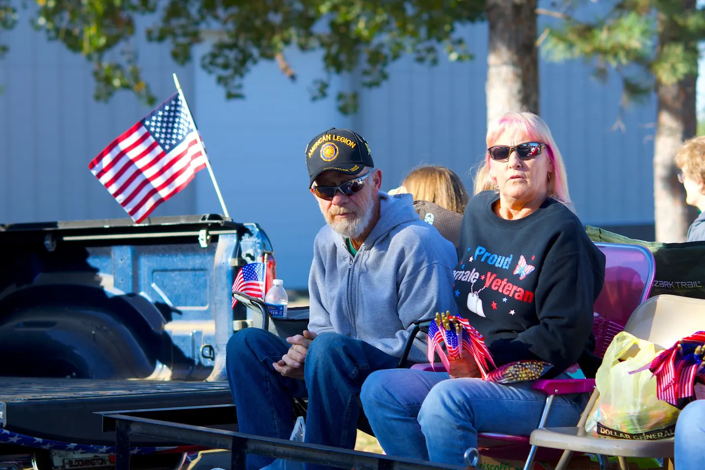 Older veteran couple with an American flag at a parade